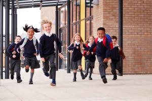 stock image of school children running