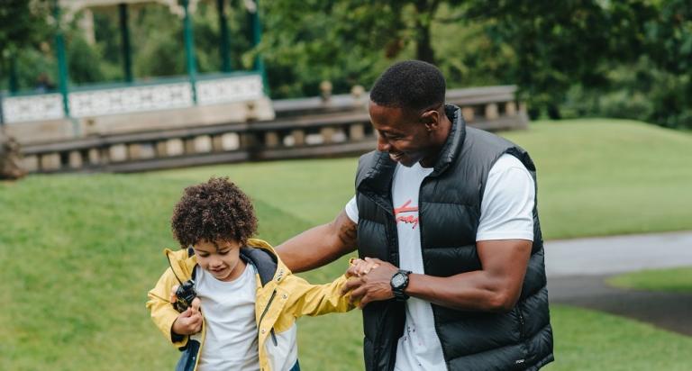 Man and young child in the park