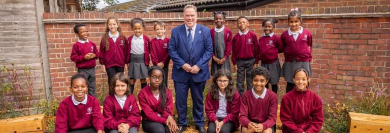 Mayor Perry standing in the middle of school children