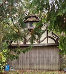 Original garage doors and an outbuilding