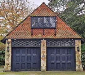 Original garage doors and an outbuilding