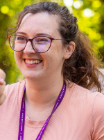 Kat Lund-Vale wearing a peach top and glasses