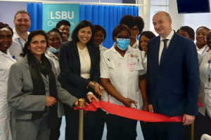 Cllrs Manju Shalhul-Hameed and Hamida Ali cutting the ribbon with LSBU staff and students