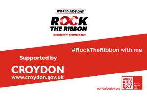 World AIDS day logo Rock the ribbon with red band and hashtag #rocktheribbon