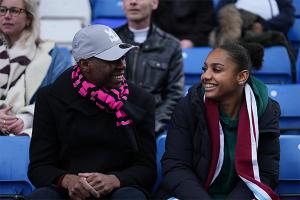 man and young girl at a sports match