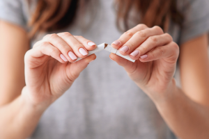 A person snapping a cigarette in half