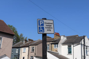 Disabled badge holders only street sign