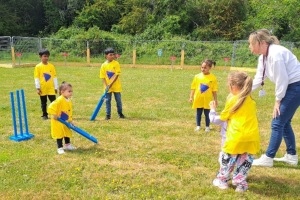 Young children playing cricket