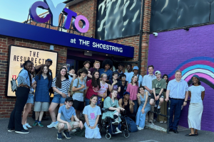 Group photo of members from CYTO and Mayor Perry, outside the entrance to the Shoestring Theatre.