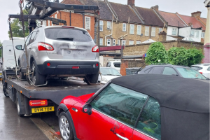 A car on top of a tow truck 