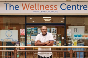A man standing outside The Wellness Centre