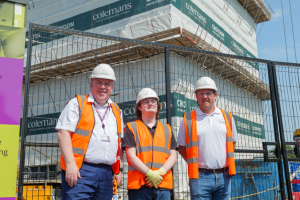 Executive Mayor Perry, local resident Lewis, and Andy Crawford from Colemans, at the Regina Road site in hard hats and high-viz