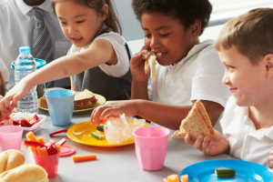 Young schoolchildren eating lunch