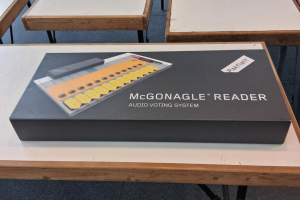 A McGonagle Reader audio voting system in a box on a table