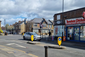 A street with a parade of shops near Croydon University Hospital