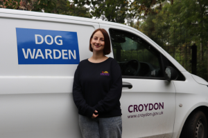 Tara Boswell, the council's dog warden, next to a white van with Dog Warden and the council logo on it