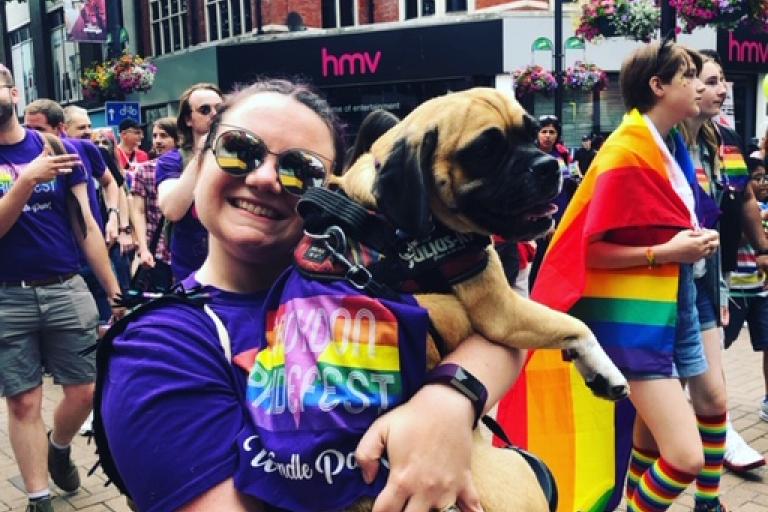 Women holding a dog at the PrideFest event. Photo credit: Pridefest