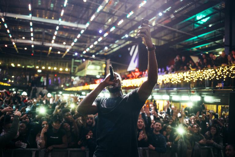 Artist called Stormzy holding a mic with a large crowd behind him. Photo credit: Boxpark