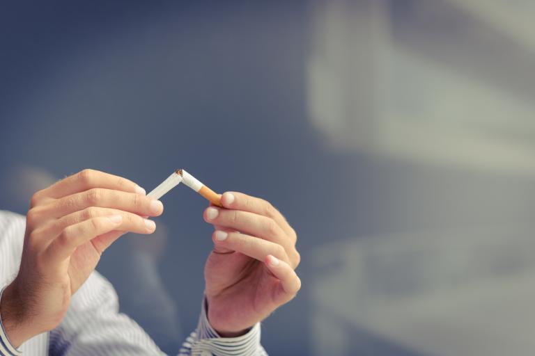 Person breaking a cigarette