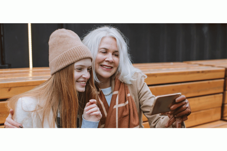 woman and a young person looking at a mobile phone