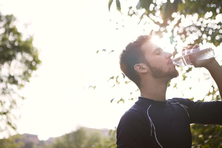 Man drinking water on a hot day